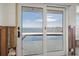 Sliding door leading to an outdoor pool and waterfront views, offering an indoor-outdoor living experience at 11005 5Th E St, Treasure Island, FL 33706