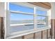 Window with a view to an outdoor pool and waterfront, creating a pleasant ambiance with natural light at 11005 5Th E St, Treasure Island, FL 33706