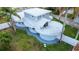 A unique modern home with a flat roof, multiple circular sections, and a well-manicured lawn at 1111 Dr M L King Jr N St, Safety Harbor, FL 34695