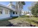 Backyard featuring mature trees, a fire pit, and a blue home with a curved design at 1111 Dr M L King Jr N St, Safety Harbor, FL 34695