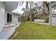 Backyard featuring a lush lawn and mature trees in a park-like setting at 1111 Dr M L King Jr N St, Safety Harbor, FL 34695