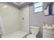 Bathroom with a white vanity, toilet and step-in shower with white surround at 1111 Dr M L King Jr N St, Safety Harbor, FL 34695