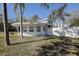 Unique circular home with a white exterior, complemented by a well-maintained lawn and mature trees at 1111 Dr M L King Jr N St, Safety Harbor, FL 34695