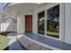 Unique home exterior with a flat roof, wooden door, and large sliding glass door, all surrounded by lush landscaping at 1111 Dr M L King Jr N St, Safety Harbor, FL 34695