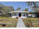 Charming home with a unique circular design, featuring a flat roof and well-manicured landscaping at 1111 Dr M L King Jr N St, Safety Harbor, FL 34695