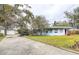 Exterior showing a blue home with a detached garage at 1111 Dr M L King Jr N St, Safety Harbor, FL 34695