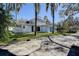 Exterior showing a blue home with a curved design and lush landscaping at 1111 Dr M L King Jr N St, Safety Harbor, FL 34695