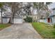 Exterior featuring a detached garage, driveway, and landscaped yard at 1111 Dr M L King Jr N St, Safety Harbor, FL 34695