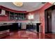 An unconventional kitchen shows the black cabinets, stainless steel appliances and mosaic backsplash at 1111 Dr M L King Jr N St, Safety Harbor, FL 34695