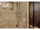 Close-up of the modern shower with glass enclosure with tiled walls and shower head at 1111 Dr M L King Jr N St, Safety Harbor, FL 34695