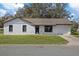 Charming single-story home with a well-manicured lawn and a classic white exterior at 12035 Meadow Ln, San Antonio, FL 33576