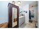 Bathroom featuring a gray vanity with a white countertop, framed mirror, and walk-in shower at 12111 Scott Dr, Dade City, FL 33525