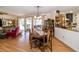 Open dining area with wood table and chairs, flowing into a living area and kitchen at 12111 Scott Dr, Dade City, FL 33525