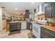 Well lit kitchen with stainless steel appliances, tiled flooring, and modern cabinetry at 12111 Scott Dr, Dade City, FL 33525