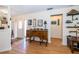 Entryway view with front door, wood floors, decorative table and view to another room at 12111 Scott Dr, Dade City, FL 33525