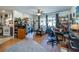 Open-concept living room with hardwood floors, multiple sitting areas, and bright windows at 12111 Scott Dr, Dade City, FL 33525