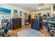 Open living space with two shelving units and an oval rug over the wood flooring at 12111 Scott Dr, Dade City, FL 33525