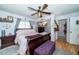 Bright main bedroom with wood flooring, gray curtains, and bedside tables at 12111 Scott Dr, Dade City, FL 33525