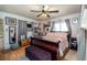 Cozy main bedroom featuring a large bed, wooden floors, and soft gray curtains at 12111 Scott Dr, Dade City, FL 33525