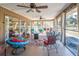 Screened-in porch offering comfortable seating, ceiling fans, and views of the outdoors at 12111 Scott Dr, Dade City, FL 33525