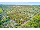 Expansive aerial view showcases the property's large lot nestled in a mature neighborhood near local waterways at 13450 Wilcox Rd, Largo, FL 33774