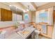 Functional bathroom with a vanity, pink tile accents, and a well-lit mirror at 13450 Wilcox Rd, Largo, FL 33774