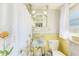 Well-maintained bathroom showcasing a daisy-themed shower curtain, yellow tile accents, and essential fixtures at 13450 Wilcox Rd, Largo, FL 33774
