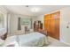 Bedroom with neutral walls and flooring features ample natural light and closet space at 13450 Wilcox Rd, Largo, FL 33774