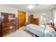 Cozy bedroom featuring wood furnishings, closet space, and an en-suite bathroom for added convenience at 13450 Wilcox Rd, Largo, FL 33774