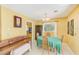 Traditional dining room with wood table, seating for four, and a vintage chandelier at 13450 Wilcox Rd, Largo, FL 33774