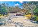 Ranch-style home featuring a two-car carport, well-maintained exterior, and a naturally landscaped front yard at 13450 Wilcox Rd, Largo, FL 33774