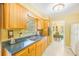 Kitchen area showcases wood cabinets, laminate counters, and stainless steel sink at 13450 Wilcox Rd, Largo, FL 33774