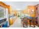Spacious kitchen flows into the dining area, featuring wood cabinets and laminate counters at 13450 Wilcox Rd, Largo, FL 33774