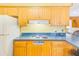 Bright kitchen features wood cabinets, laminate countertops and electric range at 13450 Wilcox Rd, Largo, FL 33774