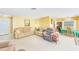 Bright living room with neutral-toned furnishings, dining table, and a welcoming ambiance at 13450 Wilcox Rd, Largo, FL 33774