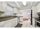 Open kitchen featuring white tile floors, stainless steel appliances and plenty of cabinet space at 13913 Cherry Brook Ln, Tampa, FL 33618