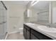 Bathroom featuring double sinks, a shower with glass doors, and a toilet at 13946 Snapper Fin Ln, Tampa, FL 33637