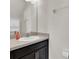Bathroom featuring a single sink vanity with dark cabinets, a large mirror, and storage at 13946 Snapper Fin Ln, Tampa, FL 33637