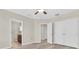 Bedroom featuring laminate flooring, ceiling fan, closet, and entrance to the bathroom at 13946 Snapper Fin Ln, Tampa, FL 33637