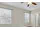 Bedroom featuring two windows, a ceiling fan, and laminate flooring at 13946 Snapper Fin Ln, Tampa, FL 33637