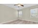 Bedroom featuring laminate flooring, a ceiling fan, and natural light from two windows at 13946 Snapper Fin Ln, Tampa, FL 33637