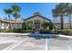 Community clubhouse featuring tropical landscaping and ample parking at 13946 Snapper Fin Ln, Tampa, FL 33637