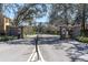Community entrance gate flanked by stone walls and manicured landscaping at 13946 Snapper Fin Ln, Tampa, FL 33637