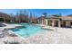 Large community pool with a sundeck and a clubhouse in the background at 13946 Snapper Fin Ln, Tampa, FL 33637