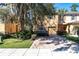 Two-story townhome with stone accents, a paved driveway, and a well-manicured front yard at 13946 Snapper Fin Ln, Tampa, FL 33637