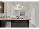 Modern kitchen featuring granite countertops, stainless steel appliances, and stylish pendant lighting at 13946 Snapper Fin Ln, Tampa, FL 33637