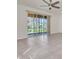 Spacious living room featuring tile floors and sliding glass doors to lanai at 13946 Snapper Fin Ln, Tampa, FL 33637