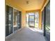 Enclosed outdoor patio with large sliding doors and a screened door leading outside at 13946 Snapper Fin Ln, Tampa, FL 33637