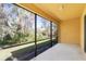 Screened porch with lush greenery, a concrete floor, and ample lighting at 13946 Snapper Fin Ln, Tampa, FL 33637
