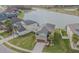 Aerial view showcases this homes stunning water view, lush green lawn, and a great view of neighborhood at 1499 Ludington Ave, Wesley Chapel, FL 33543